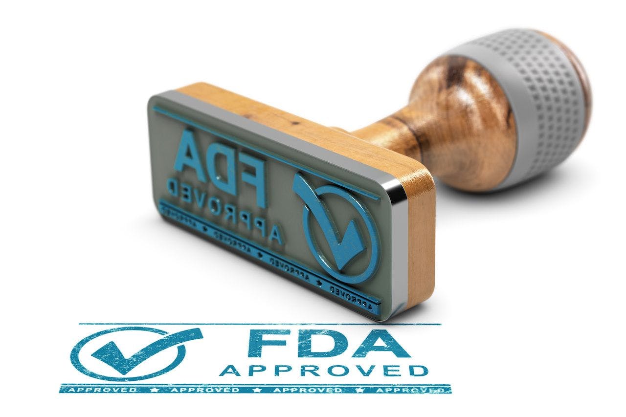 Blue FDA approval stamp | Image credit: Olivier Le Moal - stock.adobe.com